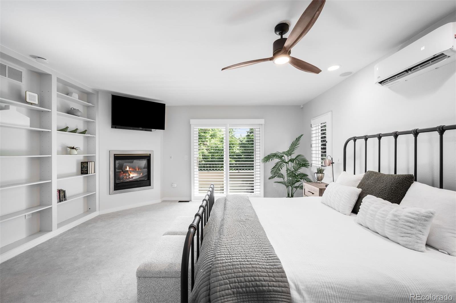 361 Detroit Street Denver, CO 80206 - Photo 32 of 46 a bed room with a bed and a television