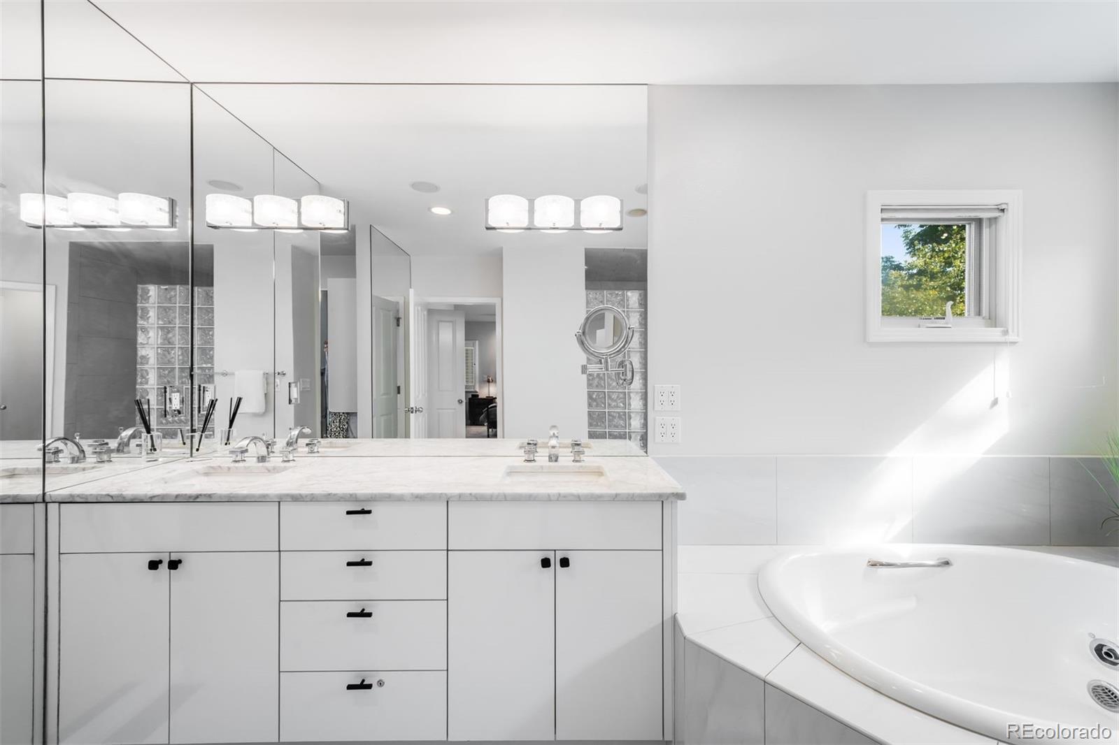 361 Detroit Street Denver, CO 80206 - Photo 34 of 46 a bathroom with a sink vanity and a mirror