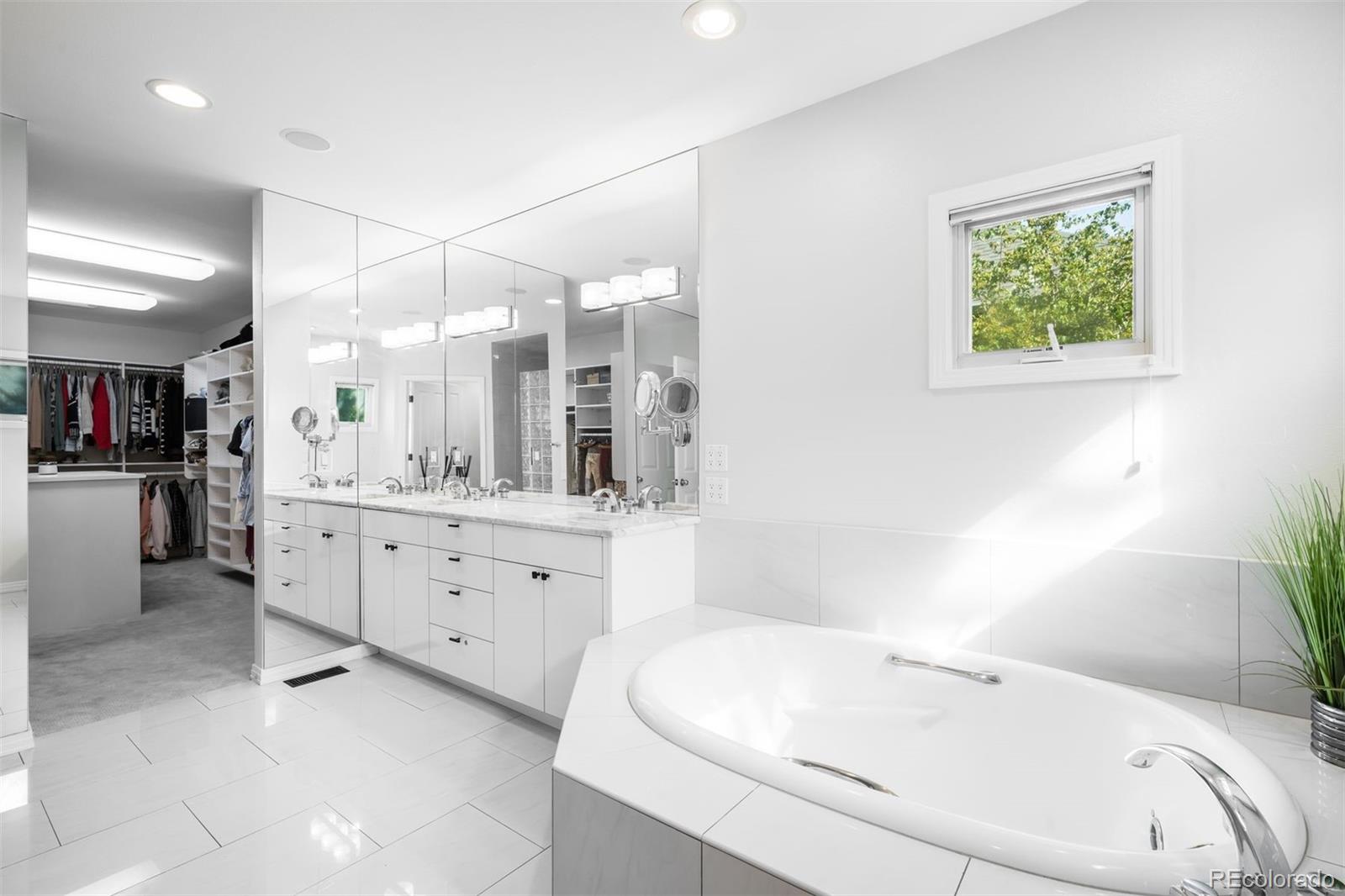 361 Detroit Street Denver, CO 80206 - Photo 35 of 46 a bathroom with a bathtub sink and mirror