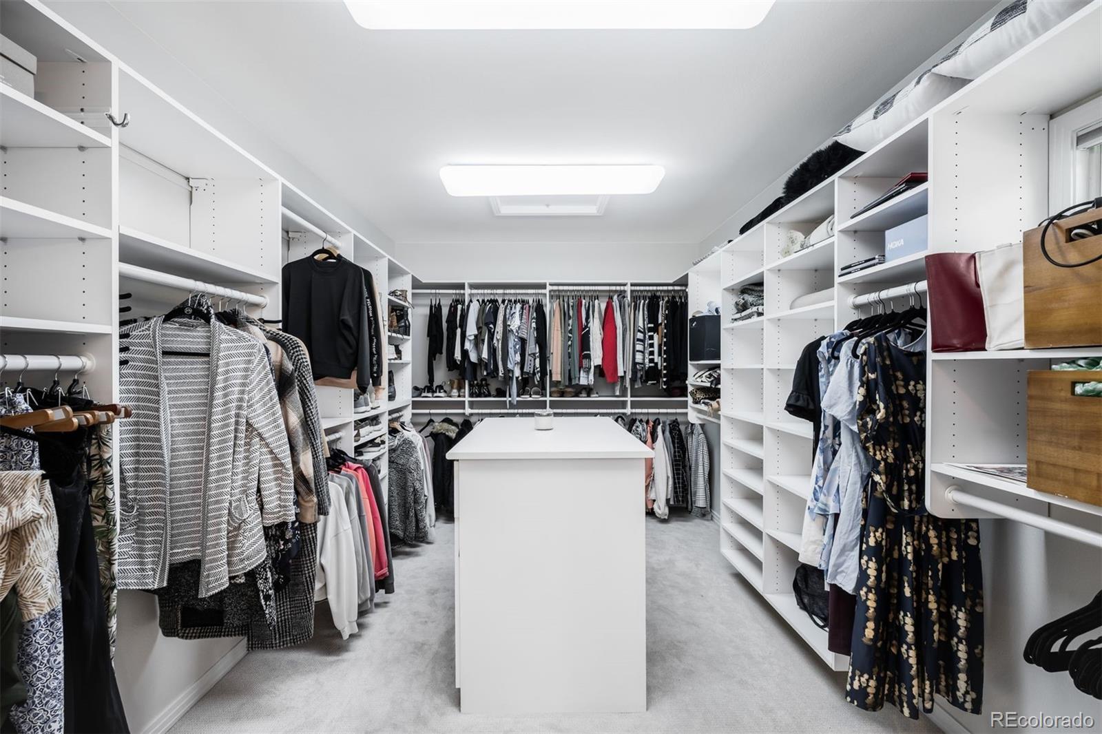 361 Detroit Street Denver, CO 80206 - Photo 36 of 46 a view of walk in closet with clothes and shoes