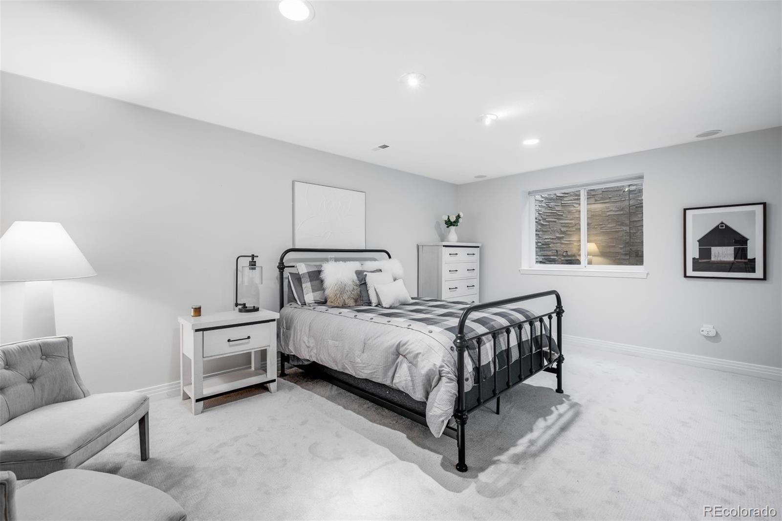 361 Detroit Street Denver, CO 80206 - Photo 37 of 46 a spacious bedroom with two beds and painting on the wall