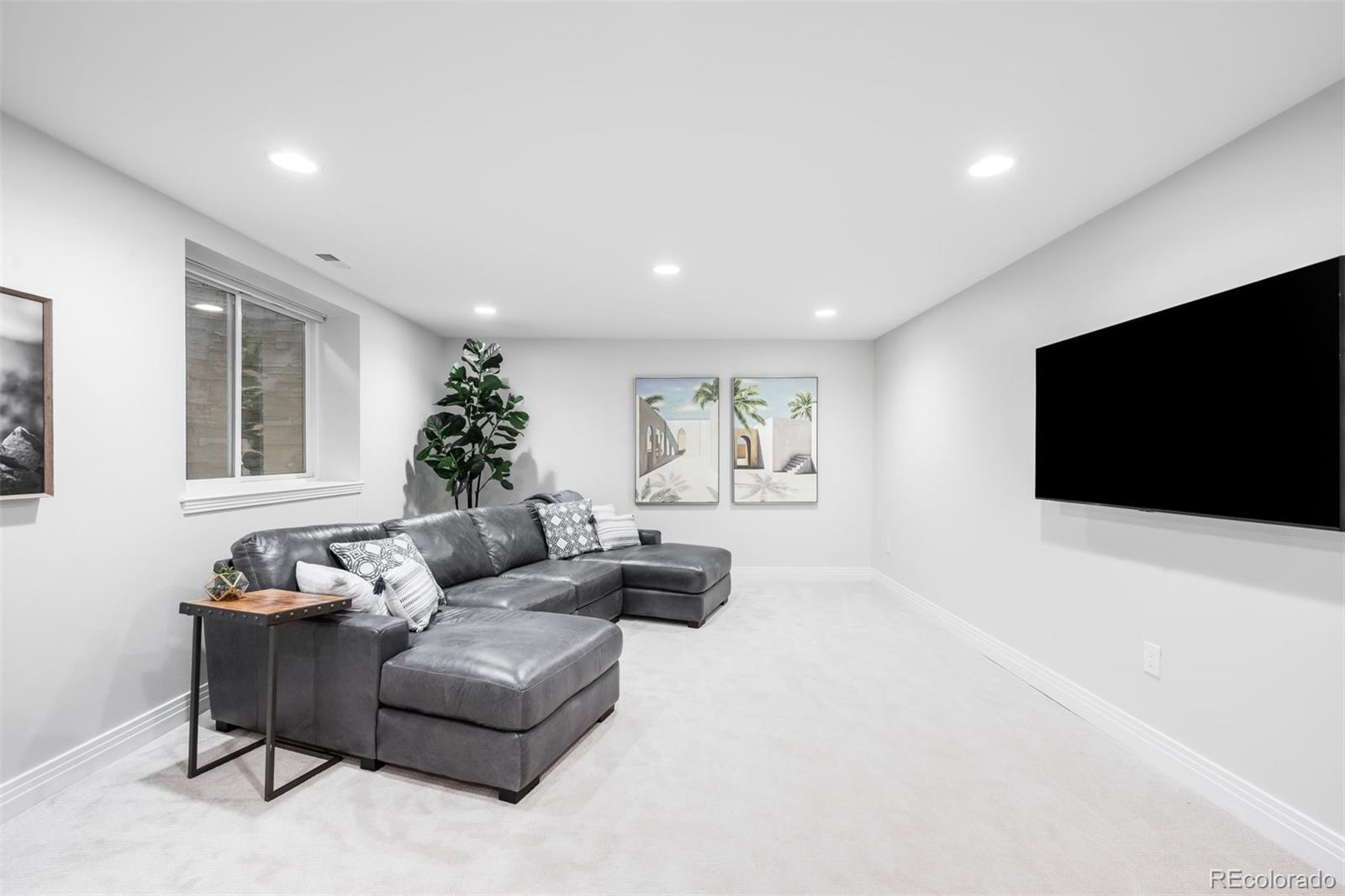 361 Detroit Street Denver, CO 80206 - Photo 40 of 46 a living room with furniture and a flat screen tv