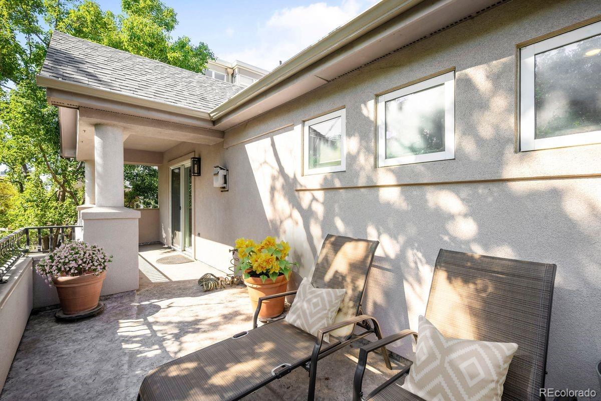 361 Detroit Street Denver, CO 80206 - Photo 42 of 46 a view of a porch with chairs and potted plants