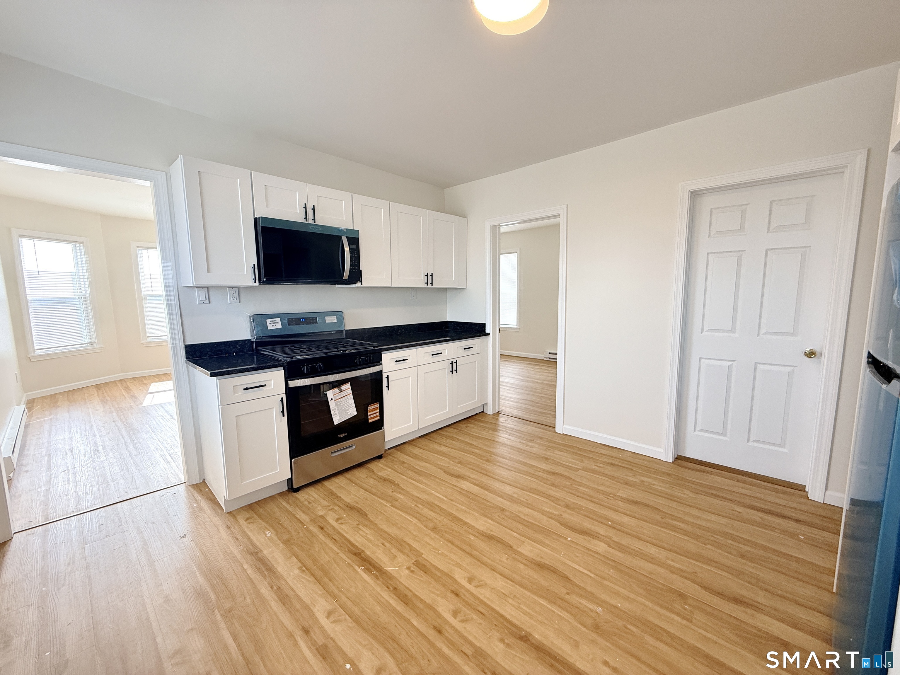 70 Lindley Street Bridgeport, CT 06604 - Photo 1 of 8 a kitchen with stainless steel appliances a stove top oven and cabinets