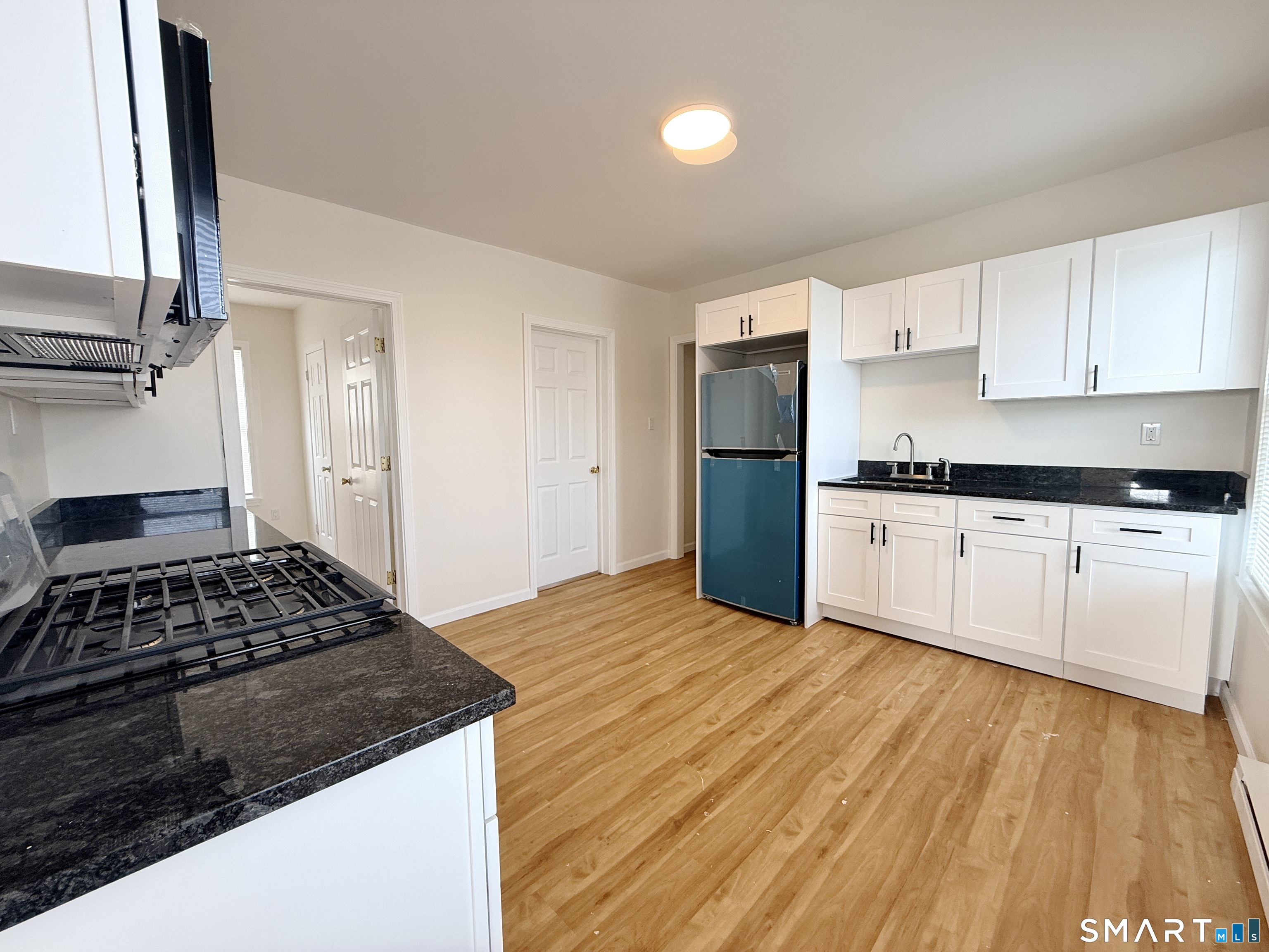 70 Lindley Street Bridgeport, CT 06604 - Photo 2 of 8 a kitchen with a stove a sink and a refrigerator