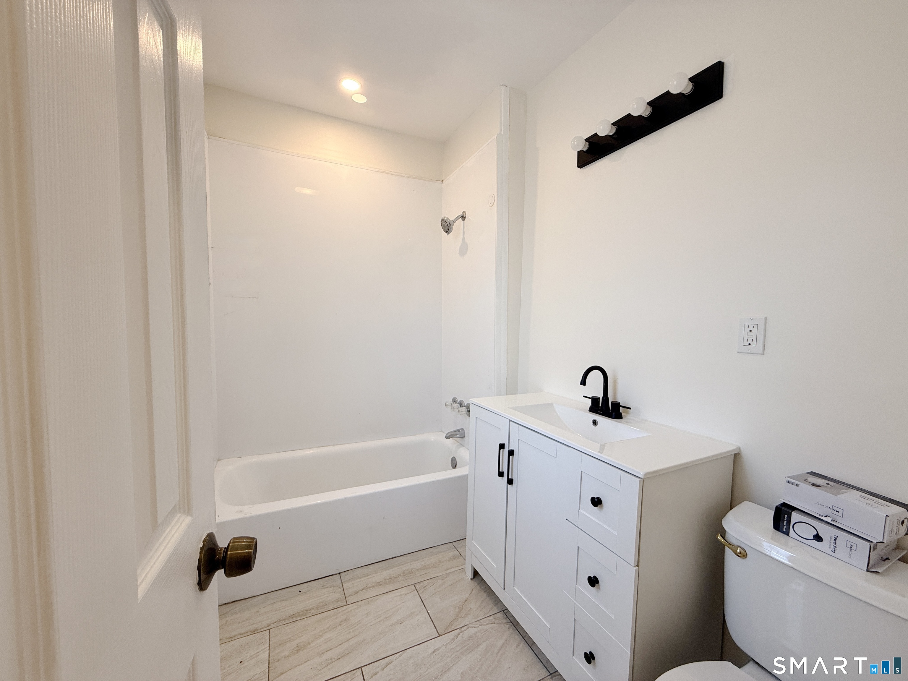 70 Lindley Street Bridgeport, CT 06604 - Photo 6 of 8 a bathroom with a bathtub a toilet and a sink