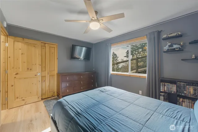 a bedroom with a bed and a window