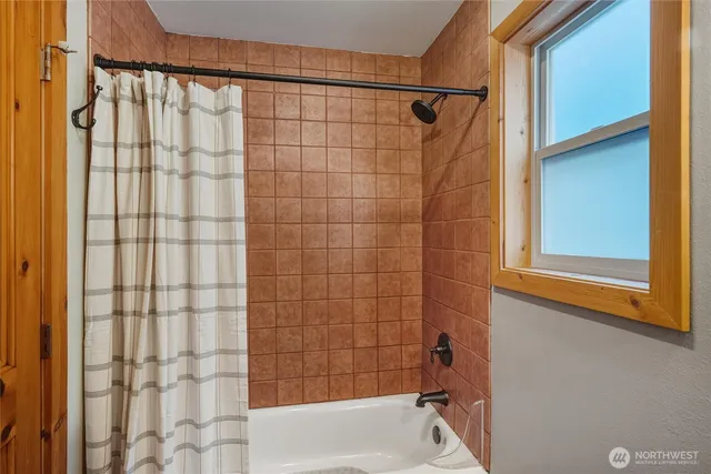 a bathroom with a shower curtain and a bathtub
