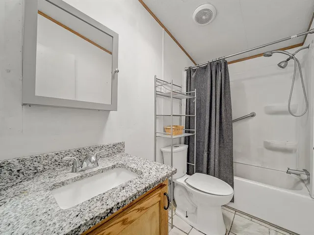 a view of a house with backyard porch and sitting area