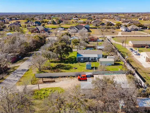 an aerial view of a house with swimming pool and outdoor seating