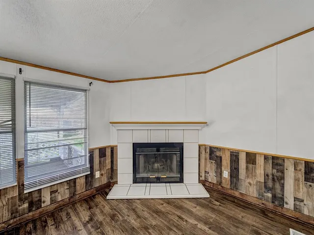 a living room with furniture a window and a fireplace