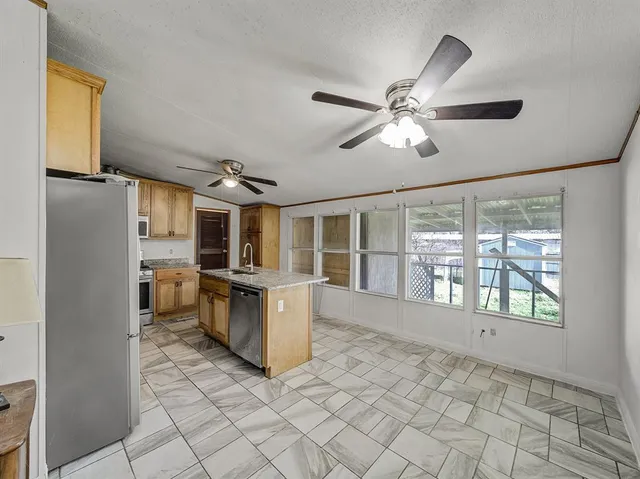 a kitchen with a sink appliances and cabinets