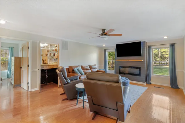 a living room with furniture a fireplace and a flat screen tv