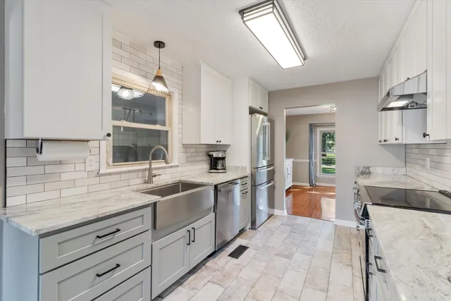 a kitchen with a sink stove and cabinets