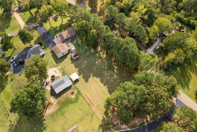 an aerial view of residential houses with yard