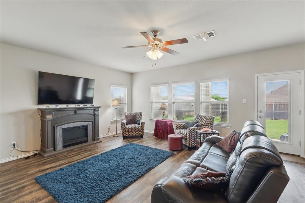 3013 Dominion Street Denton, TX 76209 - Photo 13 of 38 a living room with furniture a flat screen tv and a fireplace