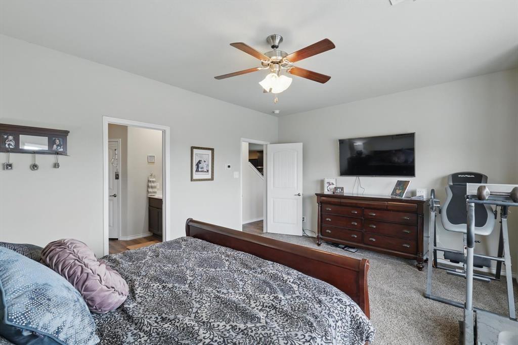 3013 Dominion Street Denton, TX 76209 - Photo 19 of 38 a bedroom with a bed and a flat screen tv