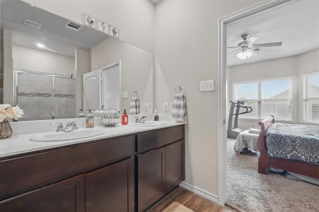 3013 Dominion Street Denton, TX 76209 - Photo 21 of 38 a en suite bathroom with double vanity and a mirror