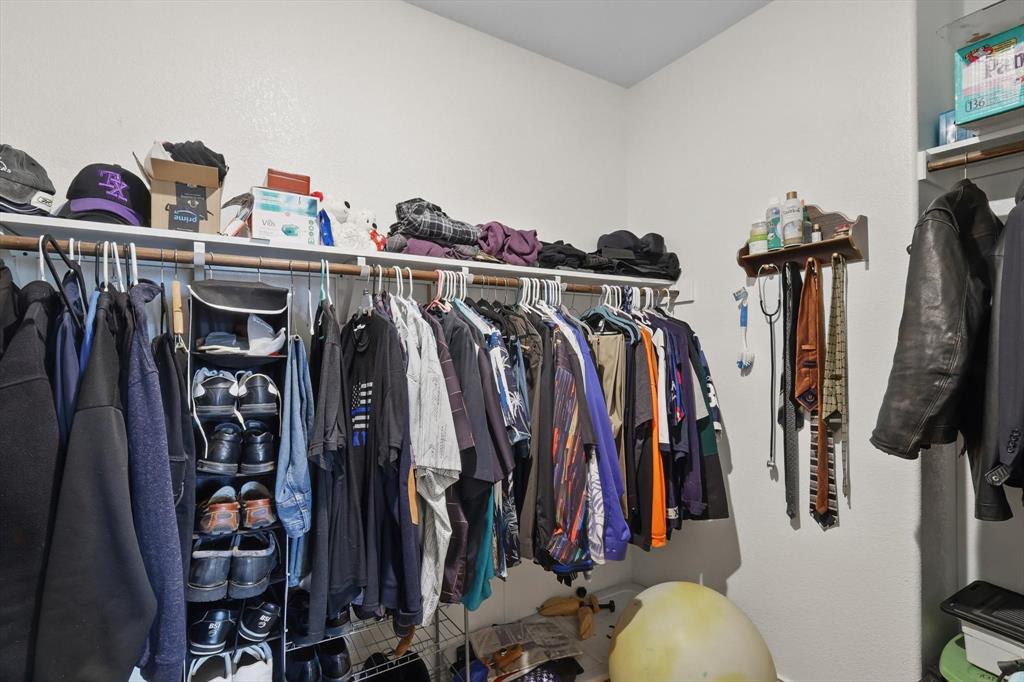3013 Dominion Street Denton, TX 76209 - Photo 23 of 38 a view of walk in closet with clothes and shoes