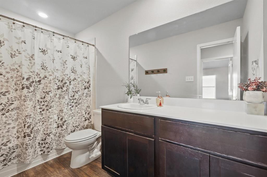3013 Dominion Street Denton, TX 76209 - Photo 26 of 38 a bathroom with a sink and a mirror