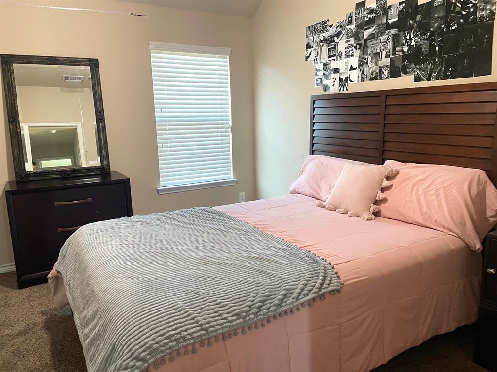 3013 Dominion Street Denton, TX 76209 - Photo 29 of 38 a bedroom with a bed and a mirror