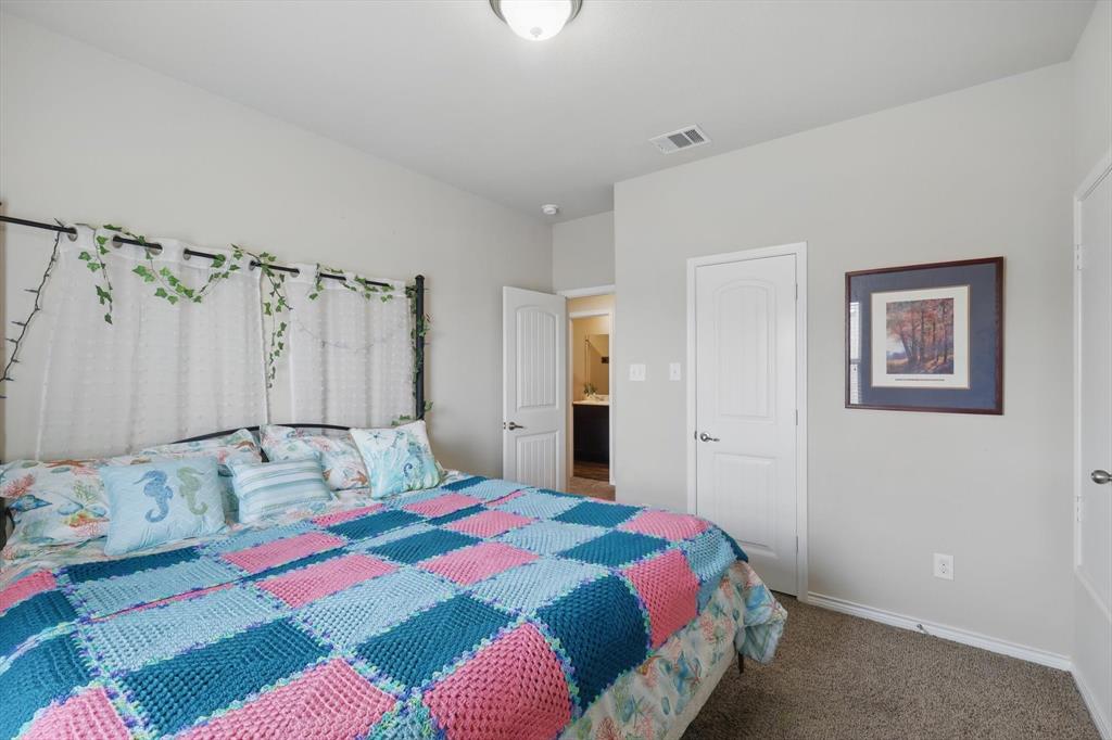 3013 Dominion Street Denton, TX 76209 - Photo 30 of 38 a bedroom with a bed and a mirror