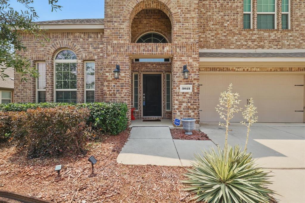 3013 Dominion Street Denton, TX 76209 - Photo 3 of 38 a front view of a house with garden