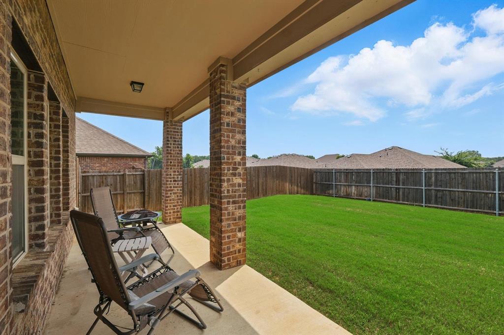 3013 Dominion Street Denton, TX 76209 - Photo 31 of 38 a view of a chairs and table in patio with a yard