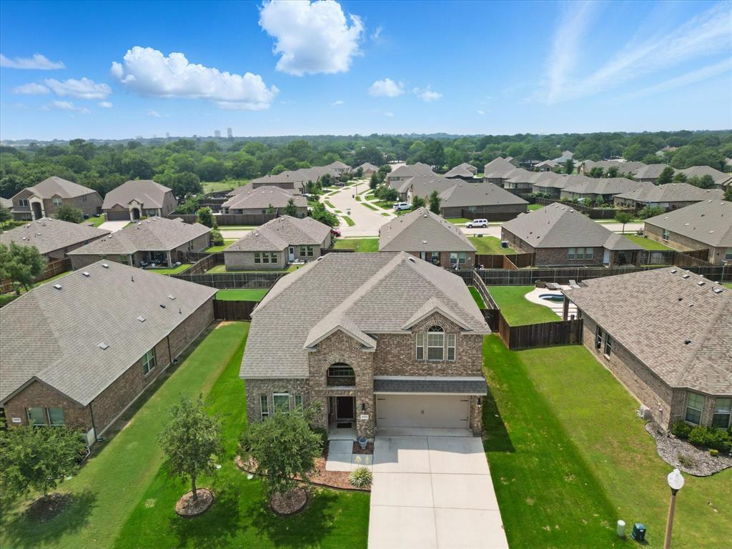 3013 Dominion Street Denton, TX 76209 - Photo 35 of 38 a view of a white house with a big yard plants and large tree