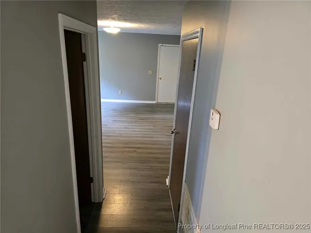 a view of hallway with wooden floor