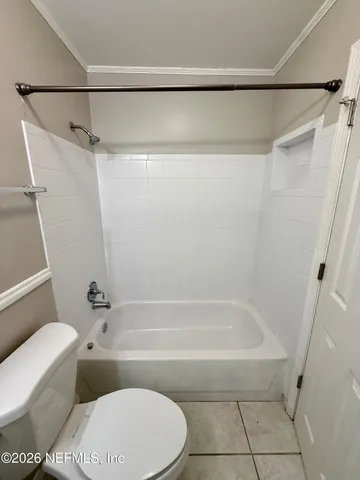 a bathroom with a bathtub and a toilet