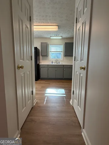 a kitchen with stainless steel appliances granite countertop a refrigerator a stove a sink and a microwave