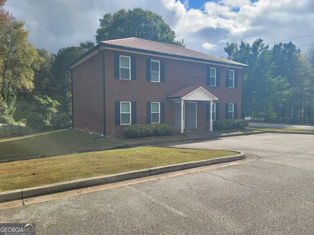 a front view of a house with yard