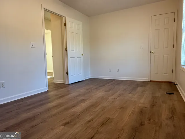 a view of an empty room and wooden floor