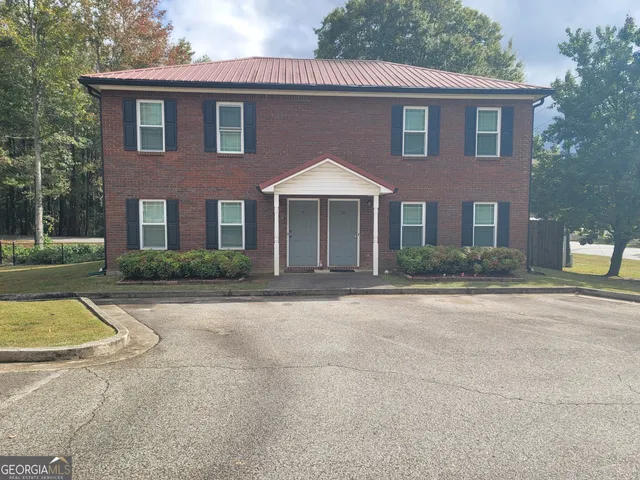 a view of entryway door with brick walls