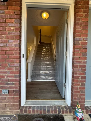 a view of a room with wooden floor and a ceiling fan