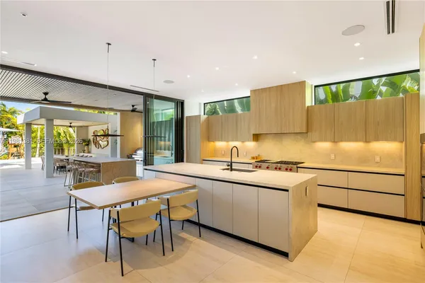 a kitchen with stainless steel appliances granite countertop a stove a sink and a refrigerator