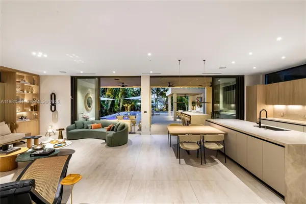 a living room with furniture and large windows