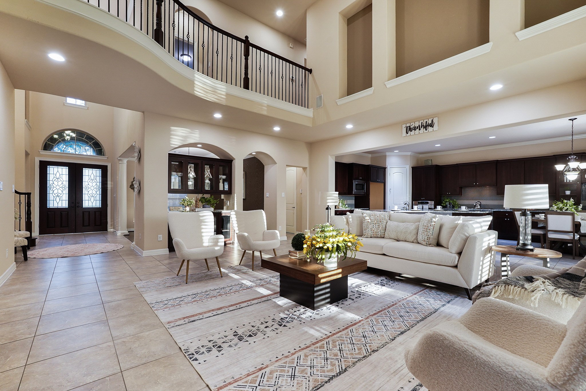 3102 Barrons Way Sugar Land, TX 77479 - Photo 42 of 42 This spacious and elegant home features a two-story family room with abundant natural light, open floor plan, and a stylish kitchen. A grand entrance and balcony enhance the luxurious feel.