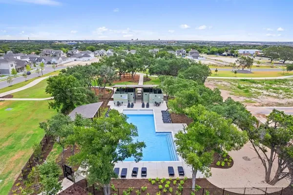 an aerial view of residential houses with outdoor space and river