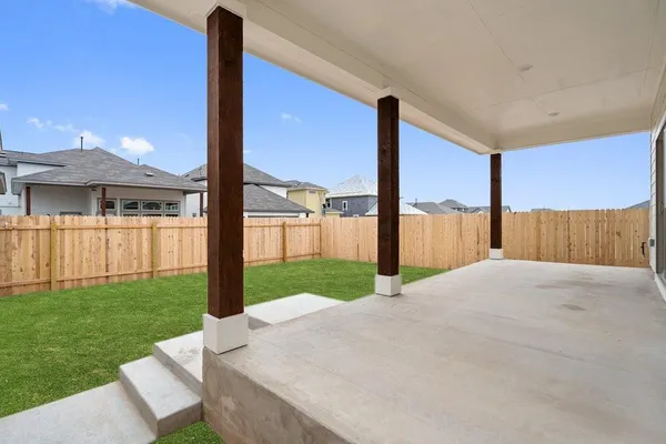 a view of a house with backyard and porch