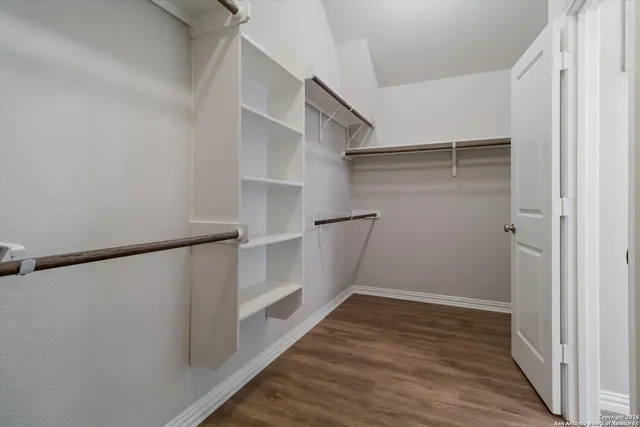 a view of walk in closet with empty racks
