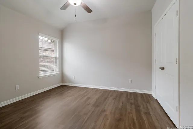 wooden floor in an empty room with a window
