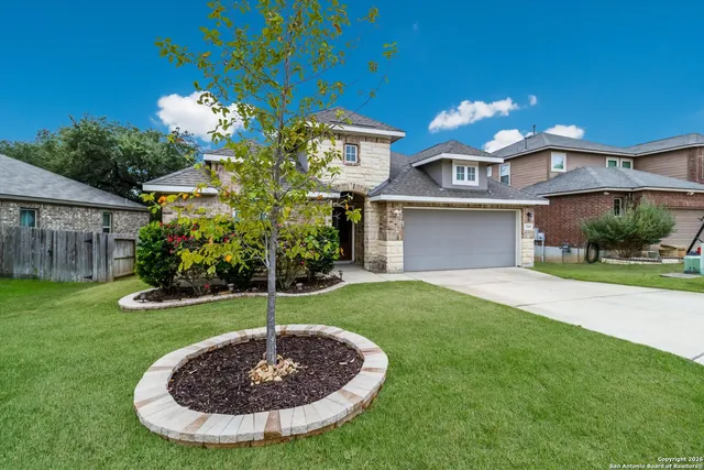 a view of a house with a backyard
