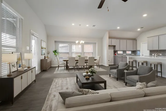 a living room with lots of furniture and kitchen view