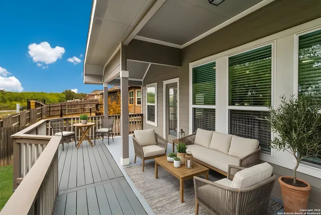 a balcony with furniture and wooden floor