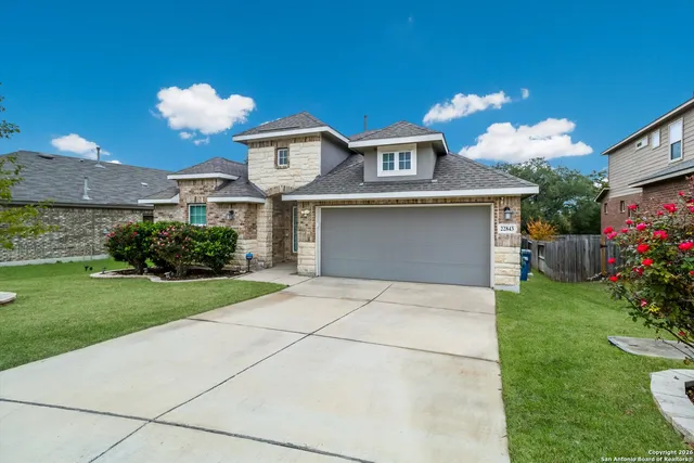 a front view of a house with a yard and a garden