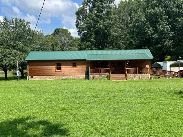a view of house with backyard
