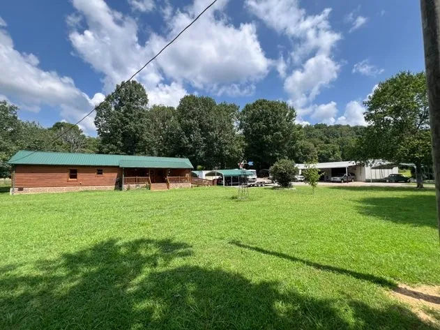 a view of yard with swimming pool and green space