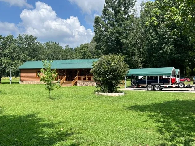 a view of house with garden and trees
